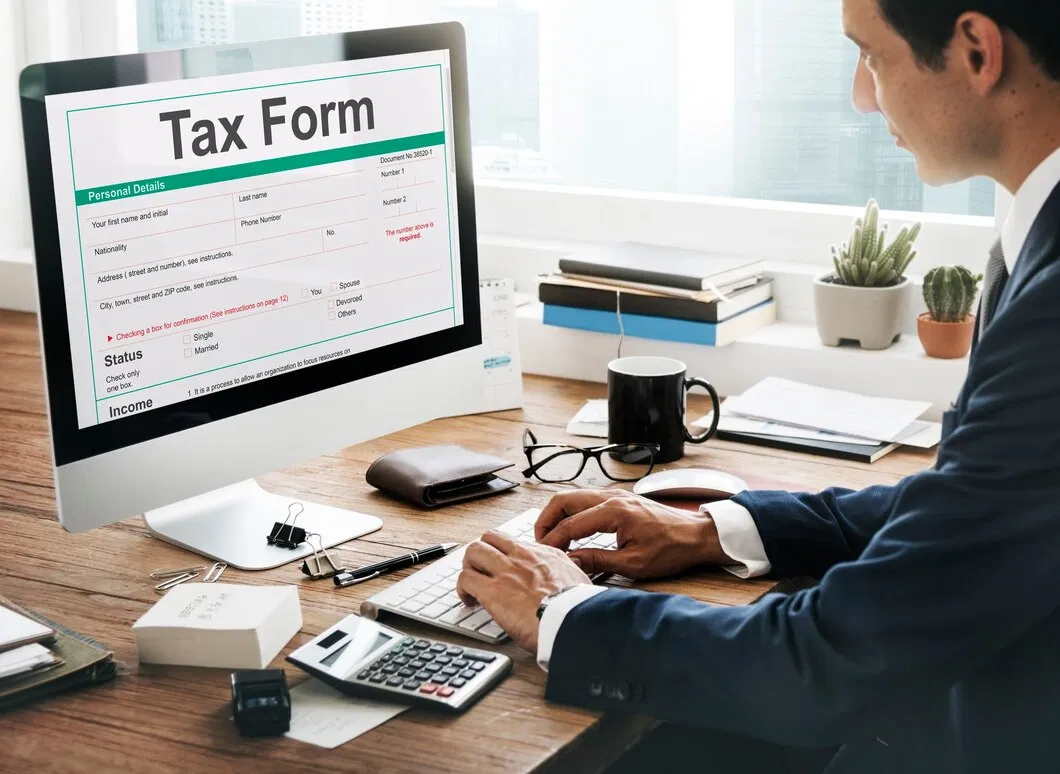 Client using online tax tools and calculator alongside Brayan & Spencer advisers